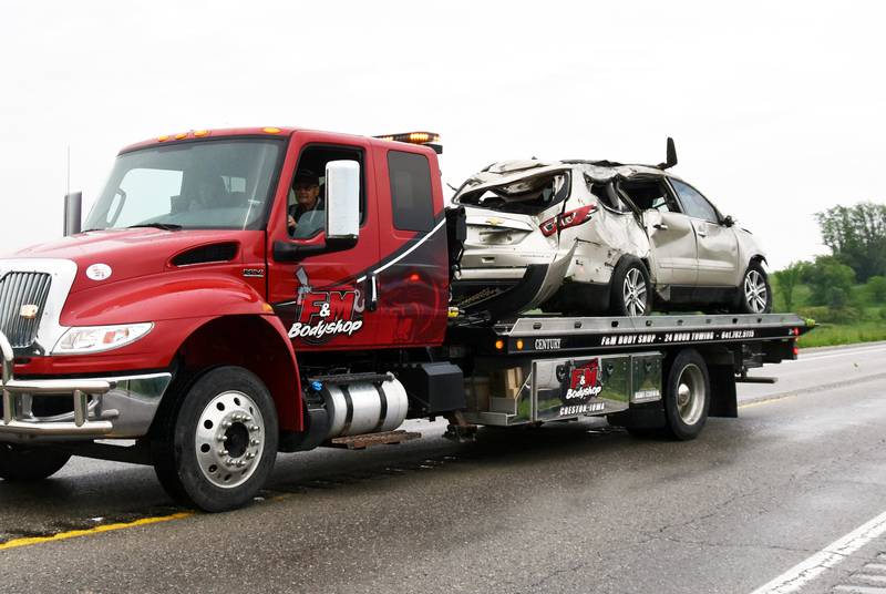 F&M Bodyshop tows a vehicle that was recovered from Grand River between Thayer and Murray Sunday afternoon. The driver, an Osceola woman, was killed in the crash.