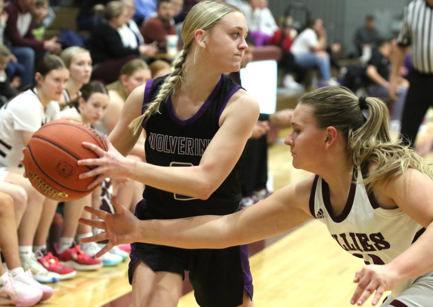 NV senior Maddie Weston looks for where to pass the ball to against a tight Shenandoah defender during a Class 2A regional road game.