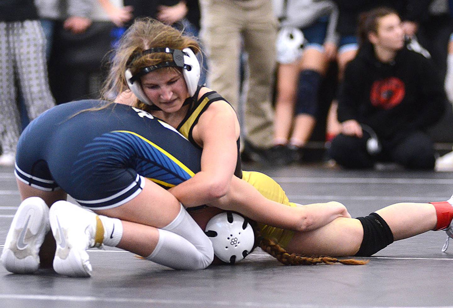 Creston freshman Eva Chesnut fights off a takedown attempt by Jersey Hilgenberg of Riverside in the 100-pound championship match at West Central Valley. Hilgenberg won an 8-6 decision.