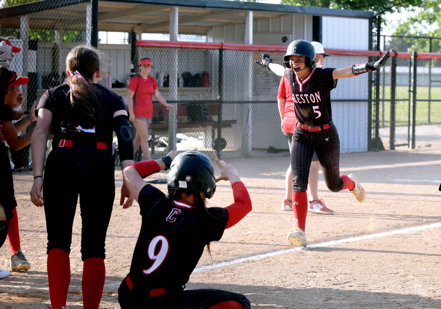 The Panthers celebrate Ava Adamson as she runs home after a grand slam in the bottom of the sixth inning in a 9-2 game one win.