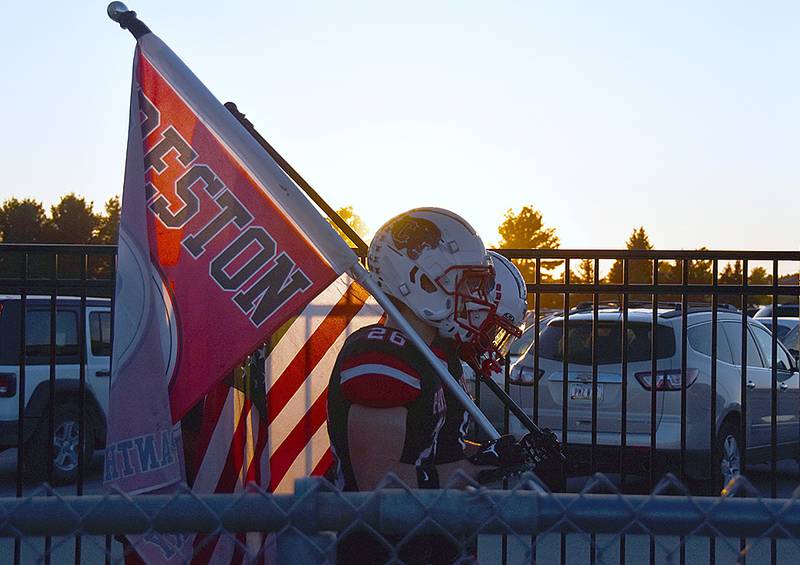 Creston football players will enter Panther Field for the final time this season on Friday against Greene County. Seniors Jackson Pettegrew (foreground) carries a Creston flag as teammate Seth Gordon carries the American flag at sunset prior to the Atlantic game on Sept. 26. Seniors will be honored at 6:30 p.m. Friday.