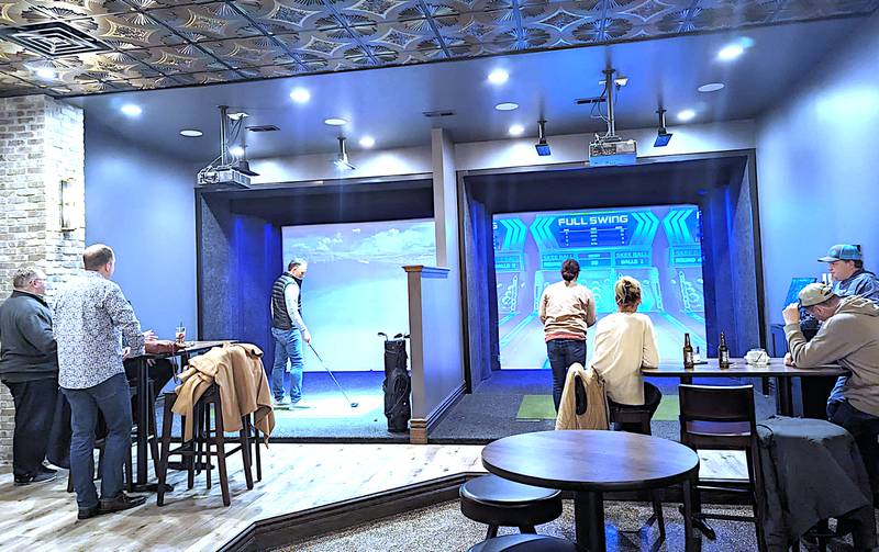Guests try their hand at sports simulators at the new Tin Lizzie's Sports Bar in Casey.