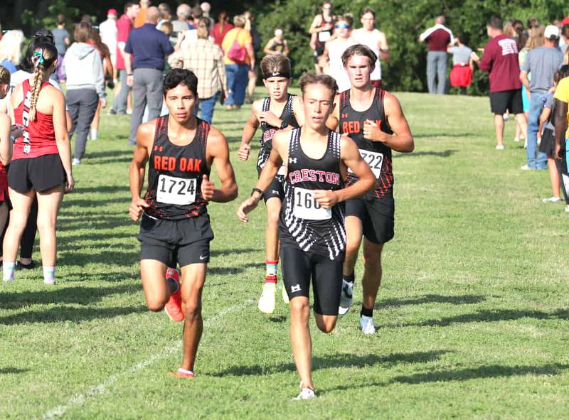 Junior Wyatt Goodenberger and freshman Ryder Baird battle Red Oak runners during the Shenandoah Early Bird meet Tuesday.