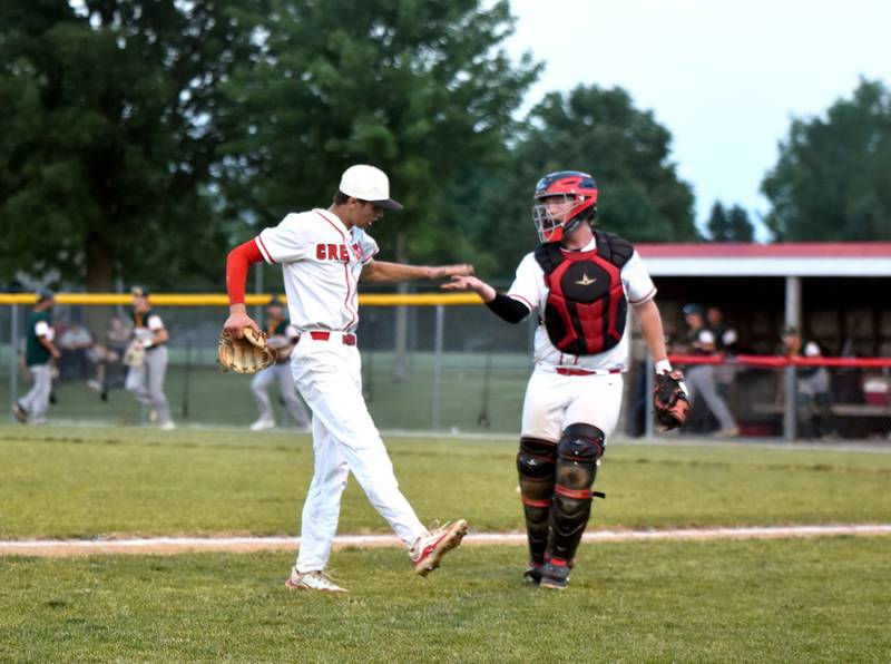 Pitcher Dylan Hoepker and catcher Tom Mikkelsen celebrate after Hoepker struck out a Falcons batter to get out of the sixth inning unscathed, stranding runners on second and third. The Panthers topped St. Albert 2-0 at home Monday.