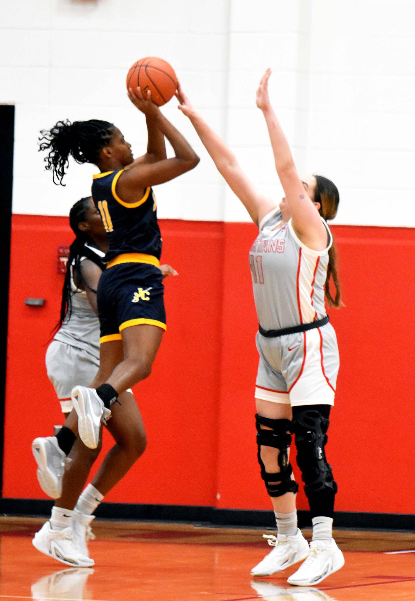 SWCC’s Mikayla “Gracie” Hearon gets a hand on the ball as Johnson County Community College’s Maizen Williams puts up a shot Wednesday. Hearon had nine points for the Spartans in the 77-47 loss.