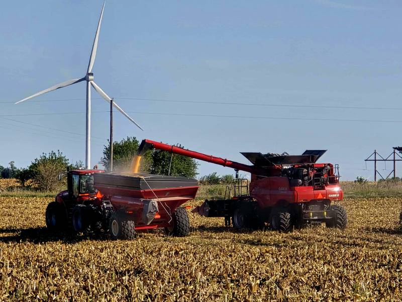 Don and Will Gordon work on harvesting corn Monday morning on their farm west of Creston