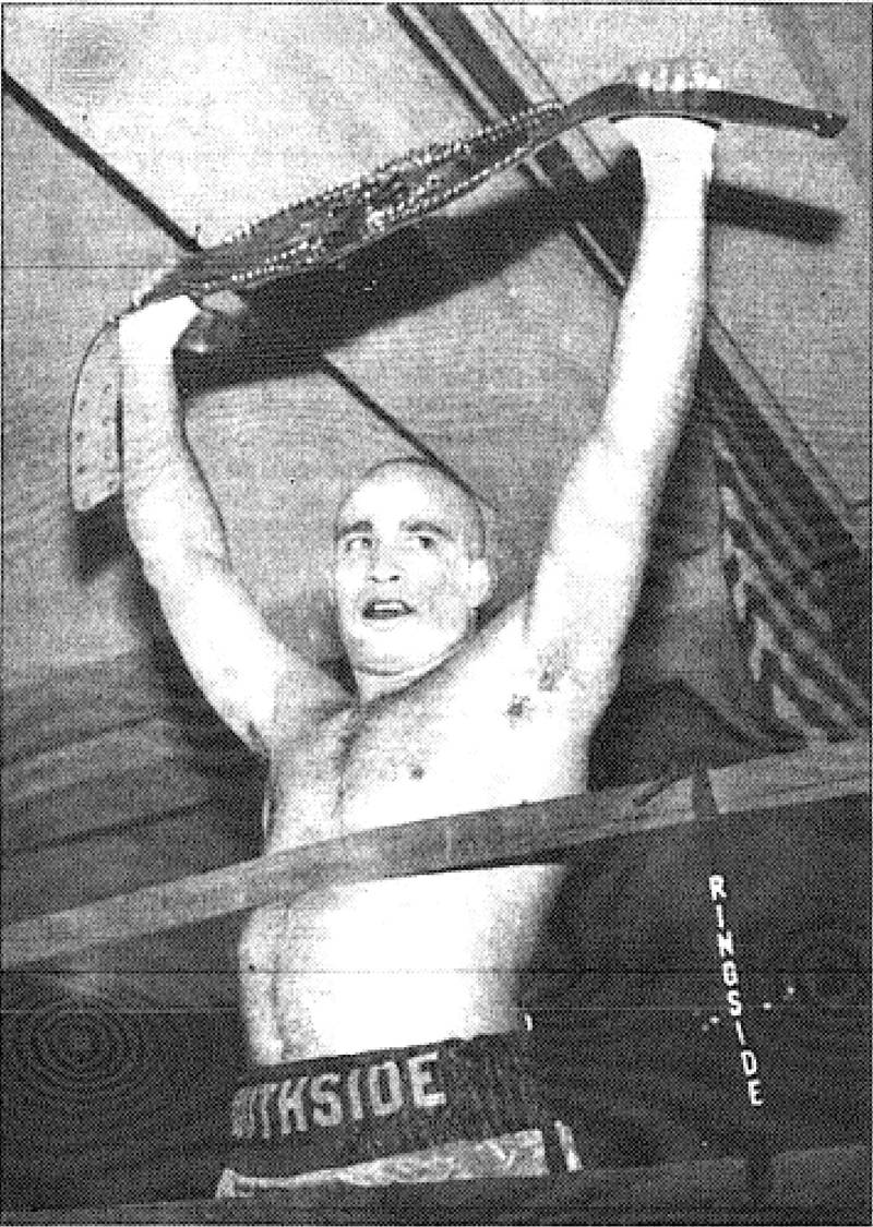 Creston boxer Allen "Southside" Smith triumphantly holds aloft the Iowa Boxing Association super middleweight belt at the Marriott Hotel ballroom. Smith won the belt with an eighth-round knockout over Des Moines boxer Charlie Negret.