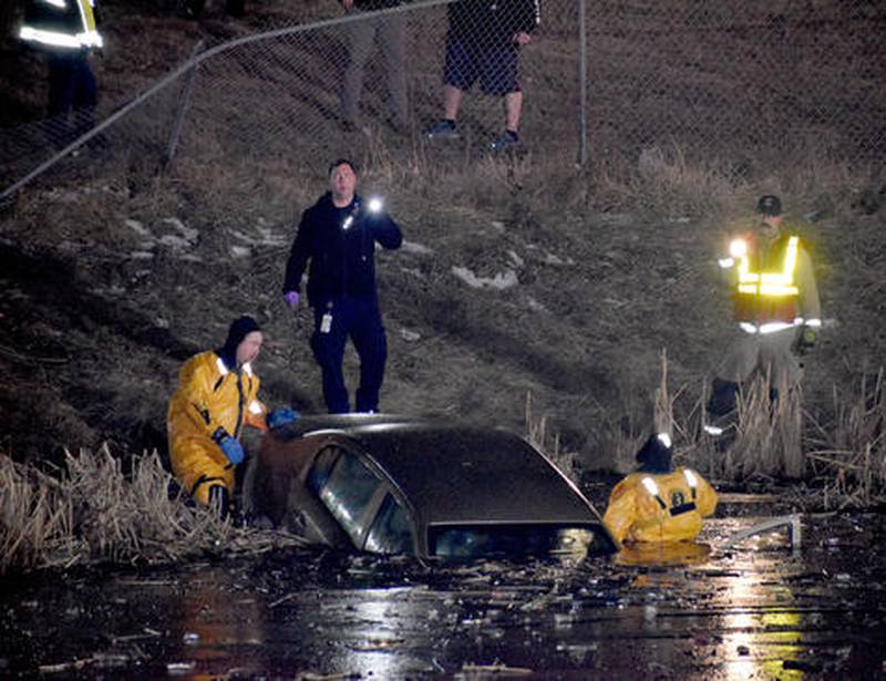 Emergency crews search an abandoned car Tuesday in the retention pond at Creston Walmart. The driver of the car was suspected of shoplifting in the store before leaving in the car at a high rate of speed, losing control and crashing into the pond. The suspect was found later in the night.