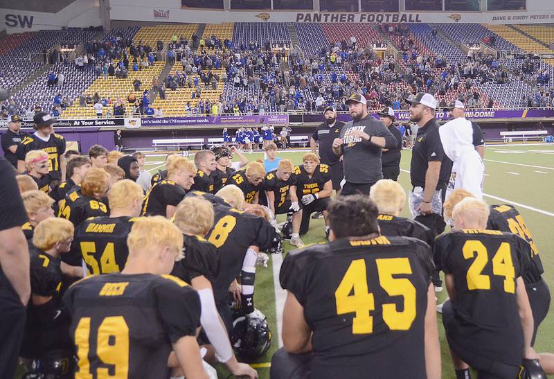 Co-coaches Michael Nardini (center) and Cole Bonde (right) address the Lenox football players after Wednesday's semifinal loss.