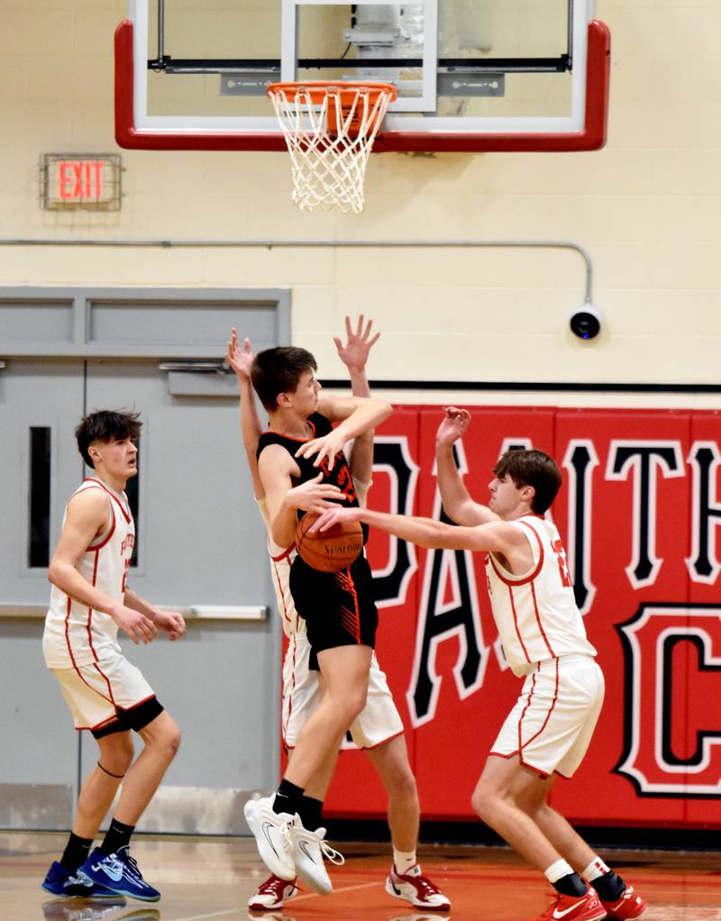 Parker Varner, right, gets a hand on the ball before a Grinnell shot. He earned the steal on the play, one of his three of the night.