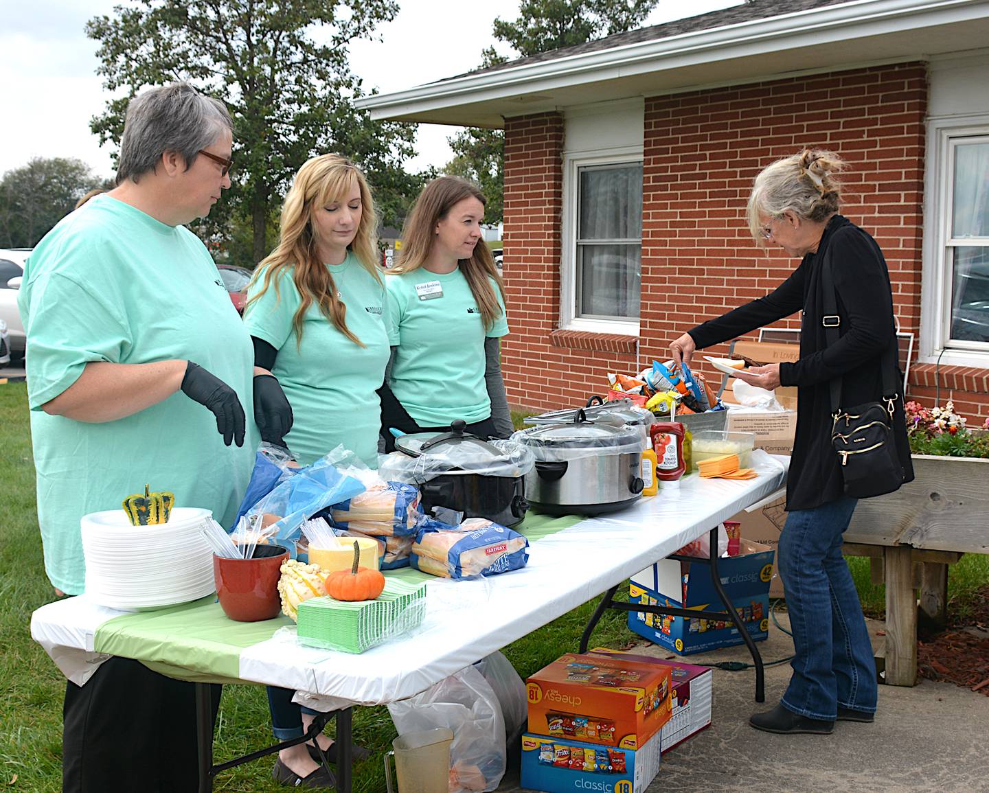 Greenfield Rehabilitation and Health Care Center staff serve hamburger meals at the 50th anniversary of the facility recently.