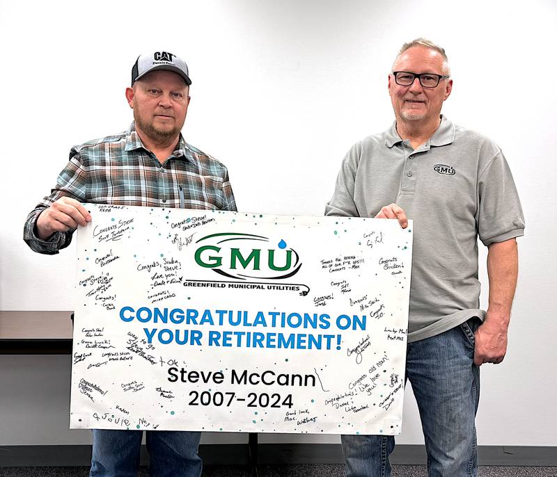 Steve McCann, right, is recognized by Greenfield Municipal Utilities General Manager Scott Tonderum Friday, Jan. 19 in a reception for him at Greenfield City Hall. McCann retired as Power Plant Foreman after 17 years with GMU.