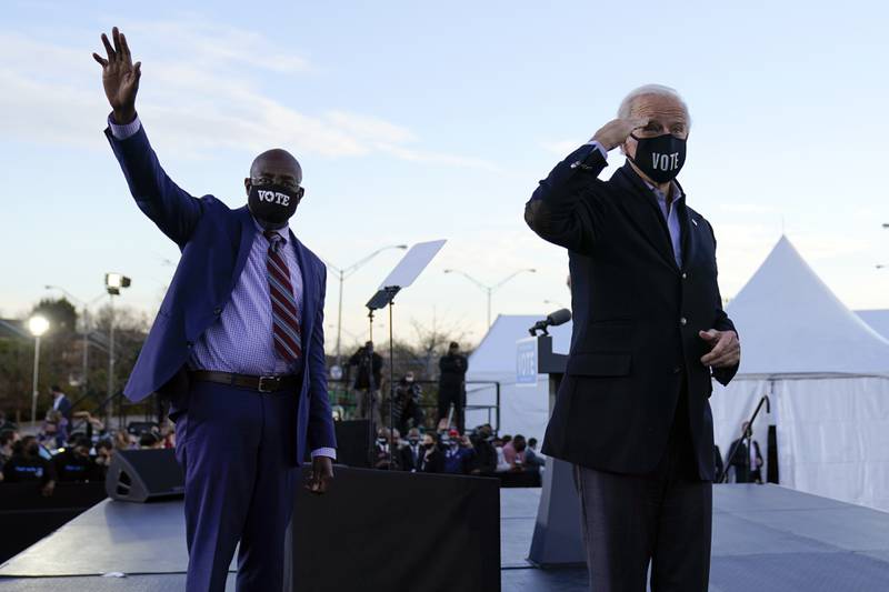 President-elect Joe Biden campaigns in Atlanta, Monday, Jan. 4, 2021, for Senate candidates Raphael Warnock, left, and Jon Ossoff. (AP Photo/Carolyn Kaster)