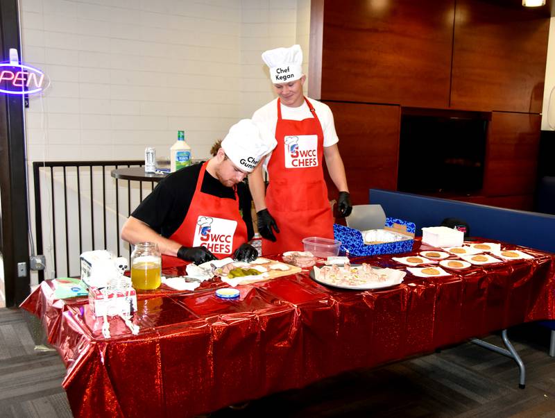 SWCC Chefs Gunner Namanny and Kegan Crogahn whip up some pickle wraps and serve homemade cookies Wednesday at the Student Center during SWCC Week. The duo has become famous on campus for their cooking videos.