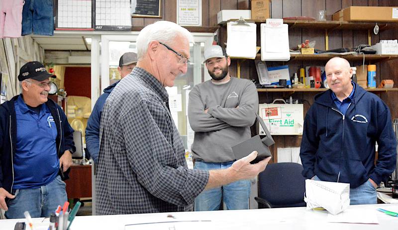 Jim Dickerson opens a commemorative watch notating his almost 61 years of service at Farmers Lumber. Dickerson retired and was honored with an open house Friday, Jan. 5.