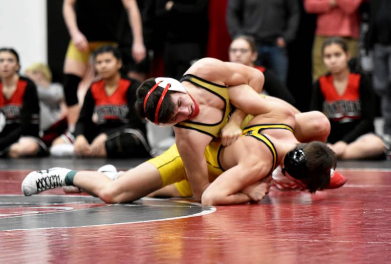 Lane Travis works on top of Jared Glendenning of Burlington Notre Dame in the finals of district wrestling Saturday in Centerville. Travis won the 132-pound bracket to advance to state.