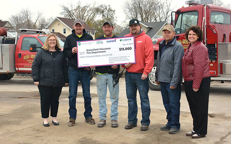 From left, at a check presentation Thursday, are Holi Weston, Farmers Electric; Greenfield firefighters Josh Oder, TJ Oder and Lance McFarland; Scott Tonderum, Greenfield Municipal Utilities and Kerry Koonce, CIPCO. GMU, Farmers and CIPCO donated $15,000 to the new fire station in Greenfield.