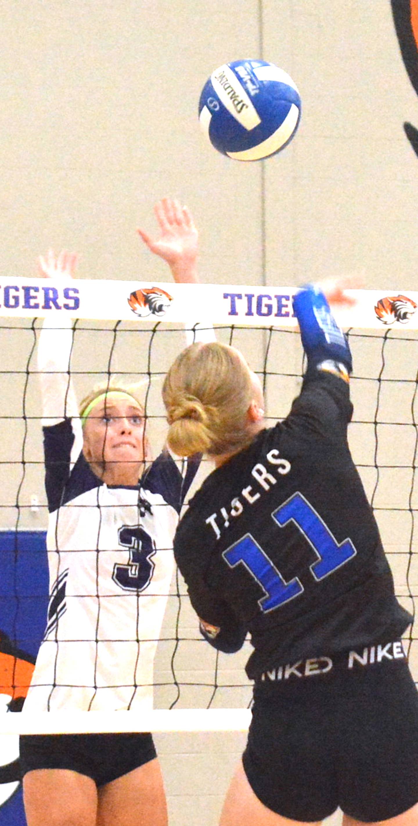 NV/OM senior Izzy Eisbach (3) goes up to block Griswold's Amanda Houser (11) in a match at Griswold Sept. 2.