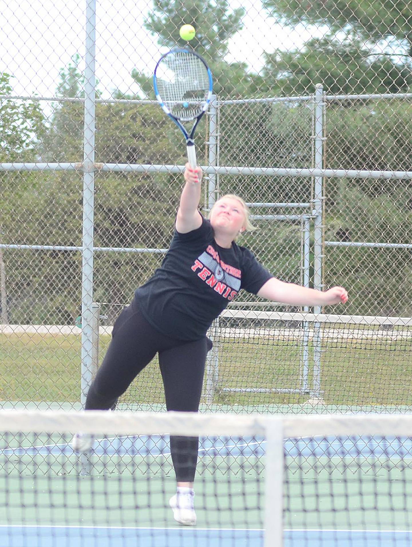 Brooke Huck of Creston serves during her No. 5 singles match against Atlantic.