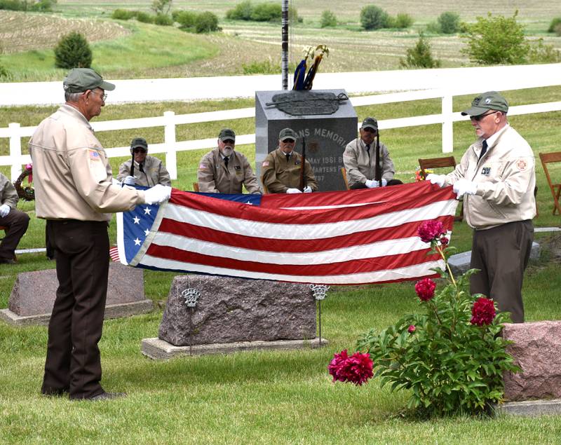 Members of Creston's VFW Post 1797 partake in the flag-folding ceremony at the Graceland Cemetery Memorial Day service Monday.
