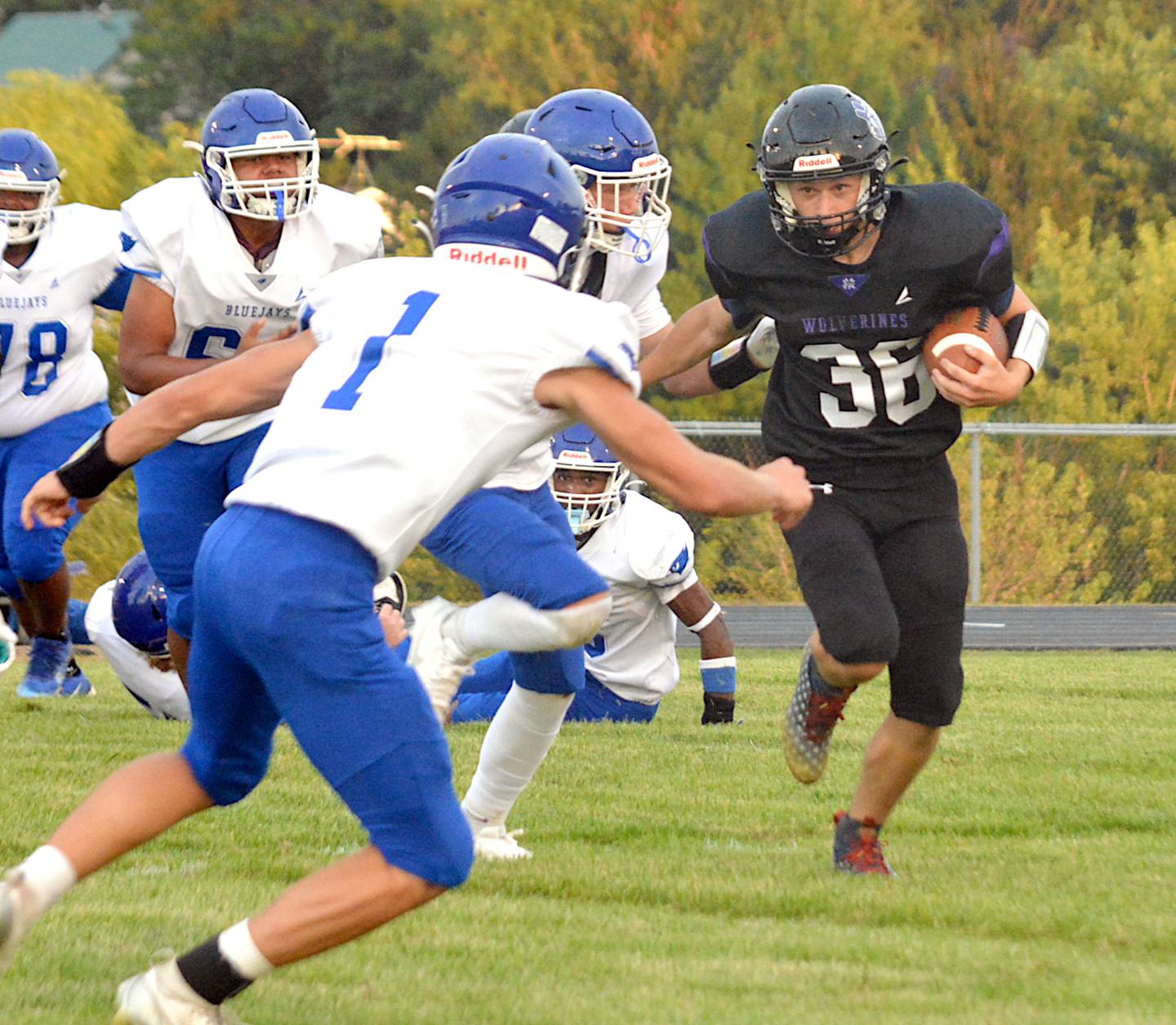 NV/OM junior Mason Payne (36) tries to get to the edge against Perry's defense in a scrimmage last Friday.