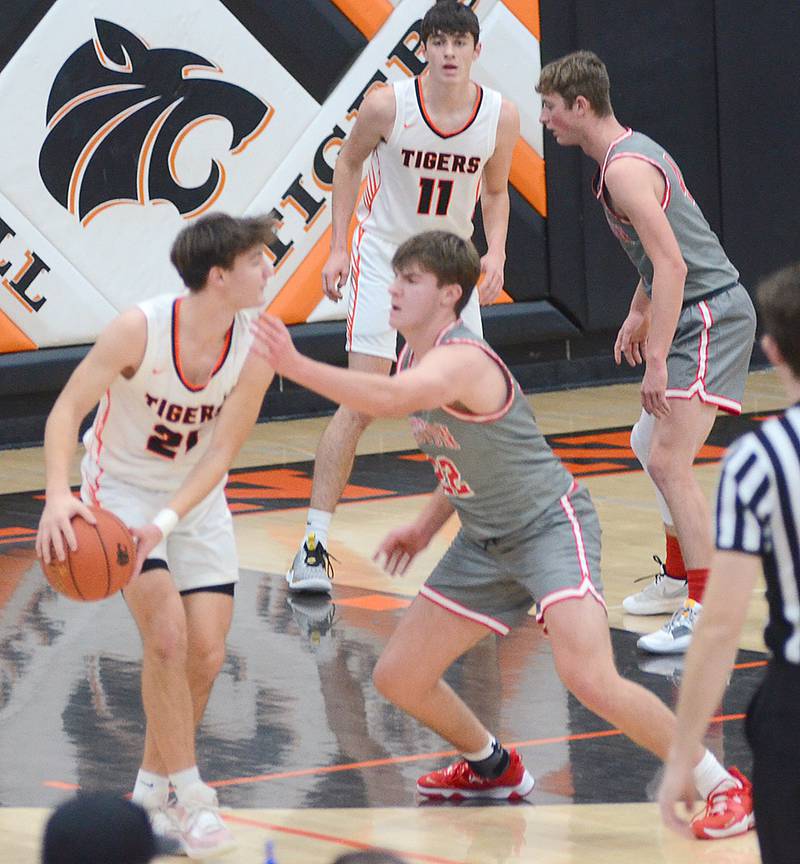 Creston's Parker Varner defends Cole Blackford of Grinnell during Monday's non-conference game. In the background, teammate Cael Turner guards Grinnell's Ryan McIlrath.
