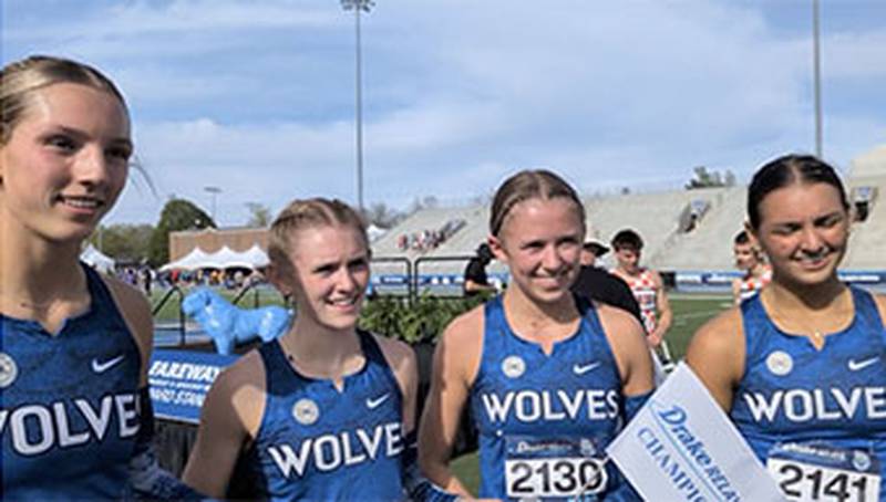 Sadie McCann (second from right) is joined by 4x400 relay teammates for an interview with media after the Wolves set an all-time Iowa record of 3:45.36.