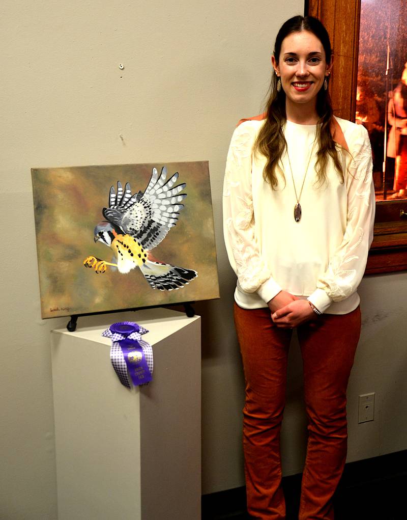 Artist Sarah King poses with one of her bird paintings, which one first at the Union County Fair this year.