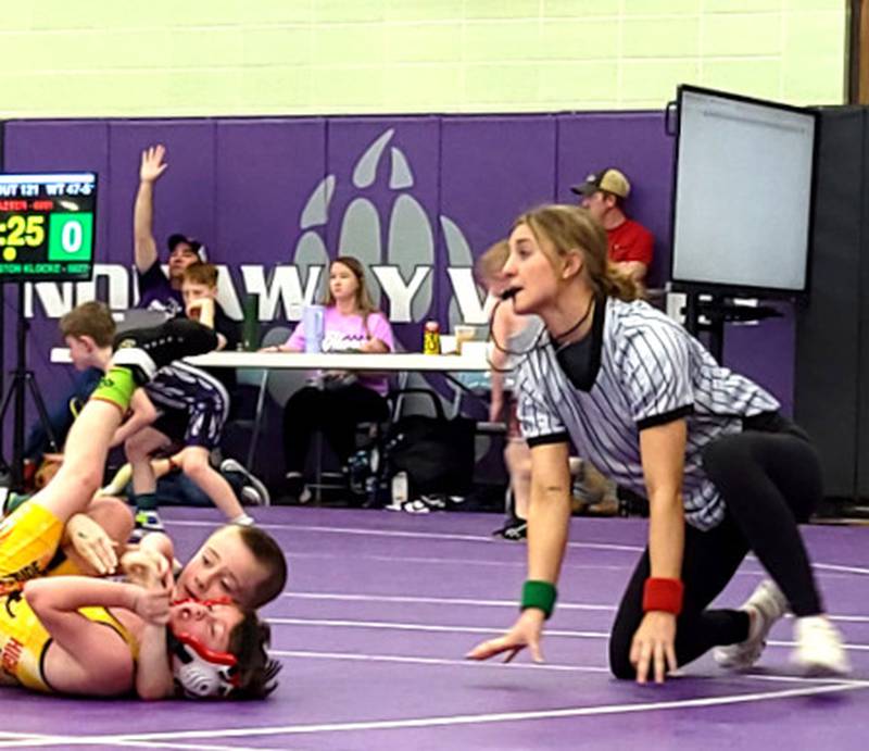 Former Southwest Valley High girl wrestler Adyson Lundquist watches a youth wrestling match as an official.