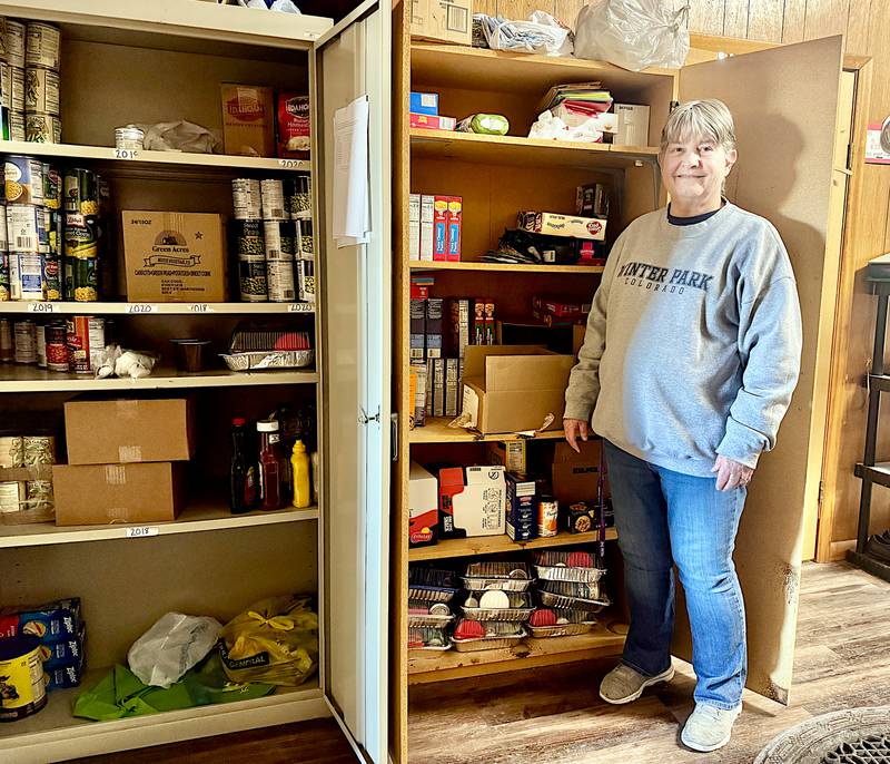 MATURA Adair County Neighborhood Center Director Raedeen Bigelow shows a well-stocked food pantry recently.