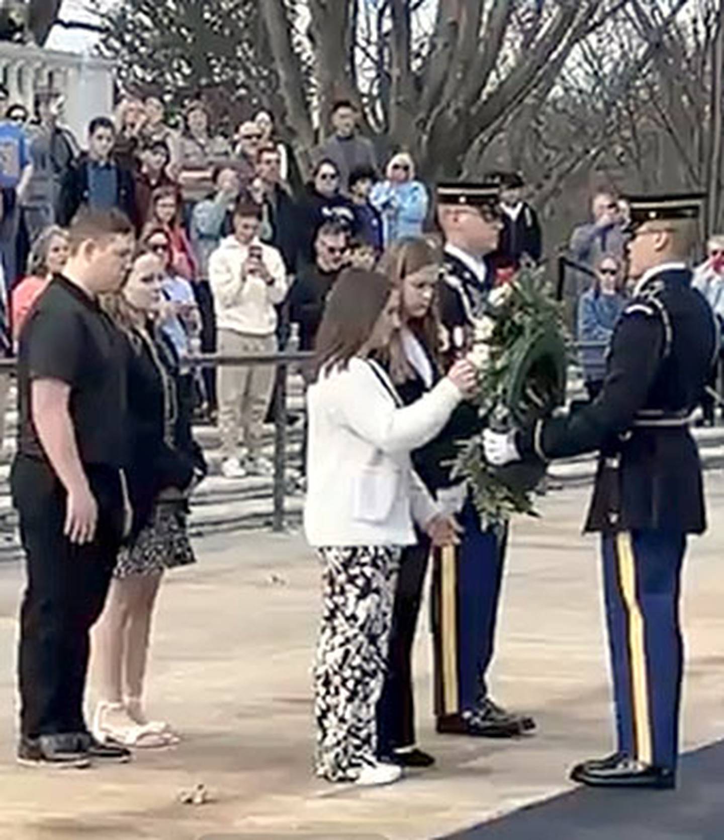 Creston students Lilly James and Lila Berning (front), and Dylan Dornack and Taylor Smith (rear) participate in the wreath laying ceremony after the Changing of the Guard at Arlington Cemetery.