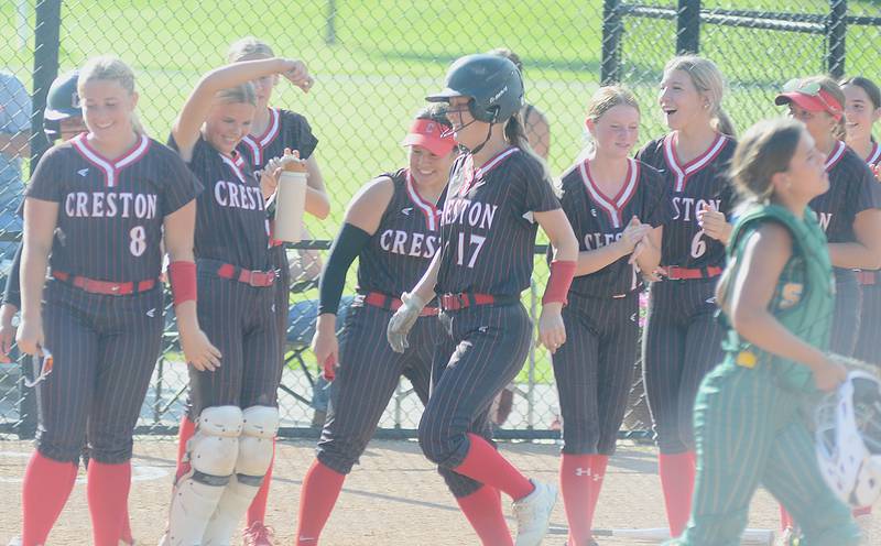 Teammates greet Creston pitcher Taryn Fredrickson (17) at home plate after she hit a two-run home run in Monday's 9-0 win over St. Albert. It was Fredrickson's third homer of the season.
