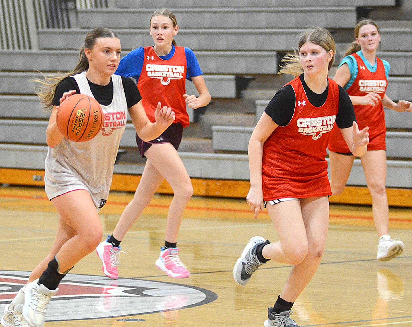 Senior point guard Hollynn Rieck leads a fast break during Tuesday's team scrimmage. Running back on defense are, from left, freshmen Bentleigh Collier and Chloe Thomson and senior Kadley Bailey.