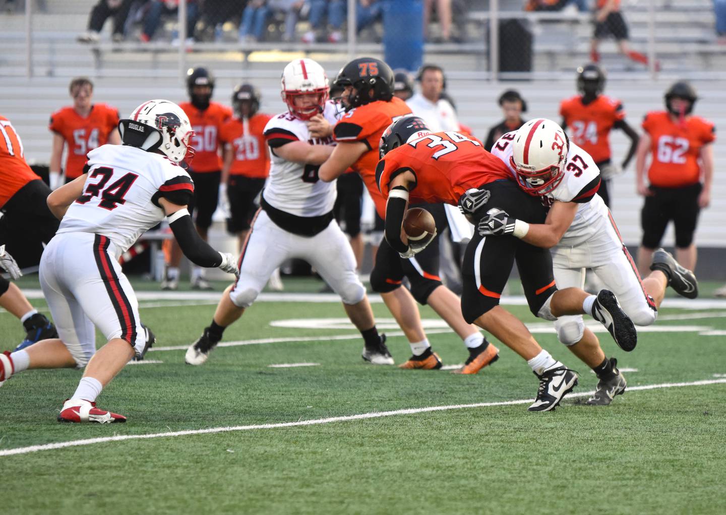 Linebacker Lucas Travis (No.37) gets the stop on the Tigers ball carrier, Chase Ragaller while Milo Stave (No.34) comes in for the assist. Travis had six solo tackles.