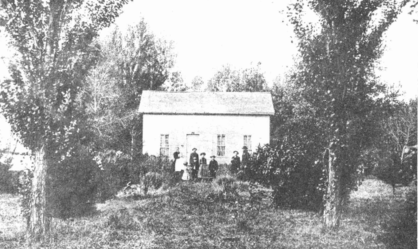 An early pioneer home, featuring Nicholas Geis and his family.