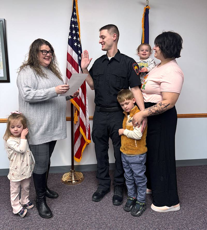 Marcus Speakman is sworn in as Greenfield's new police chief by City Clerk Jalene Sandin-Sivadge, joined by his wife, Rachael, and children Jude, Lucy and Jack.