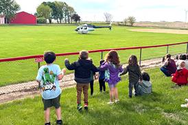 Orient helicopter pilot flies in to talk to students