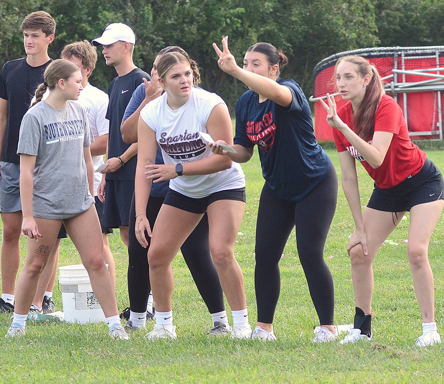 Members of one team signal a message to teammates across the field without being able to talk.