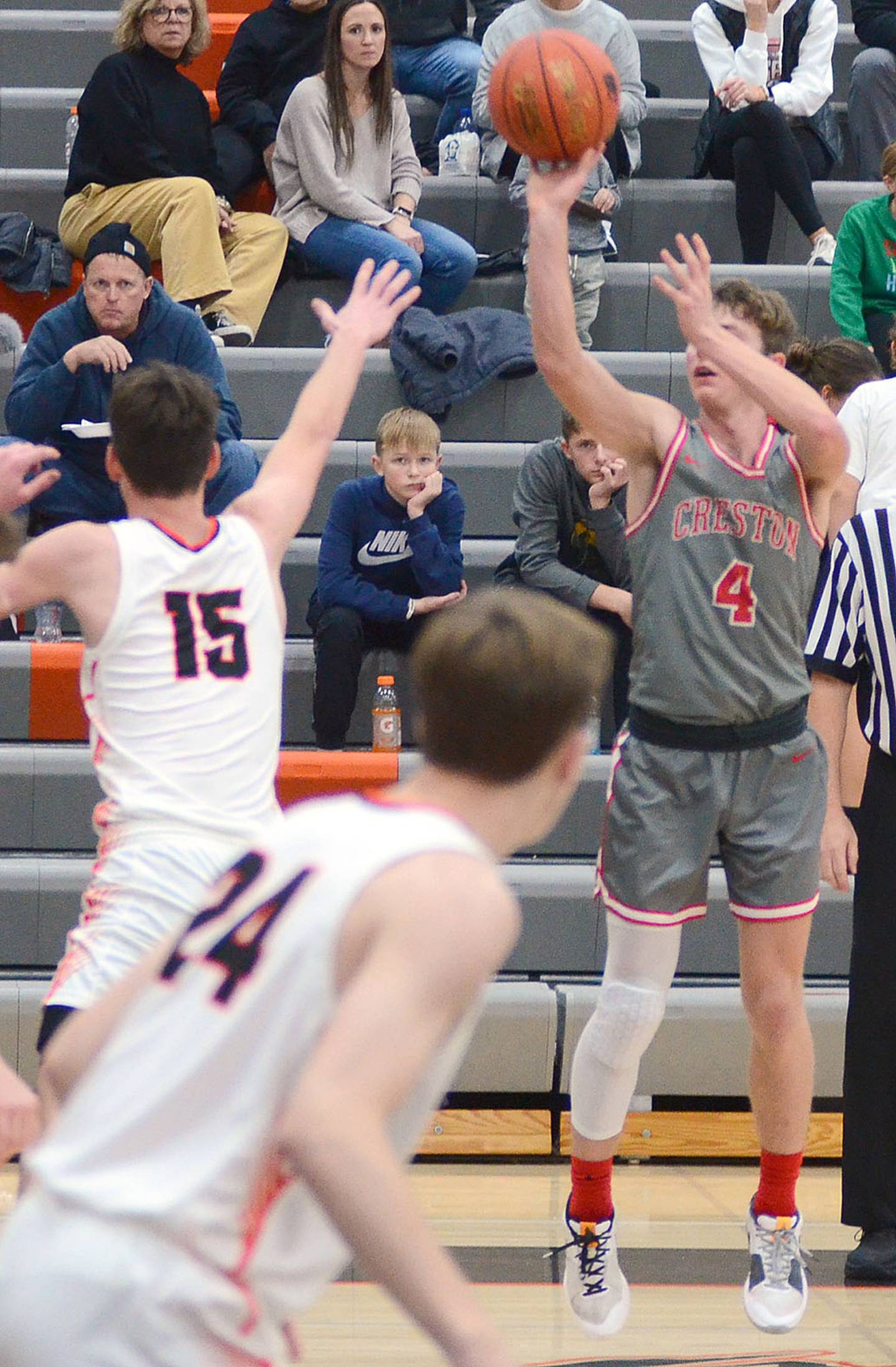 Creston guard Cael Turner shoots a 3-pointer over Grinnell defender Carson Penyich (15). Turner scored a team-high 18 points for the Panthers.