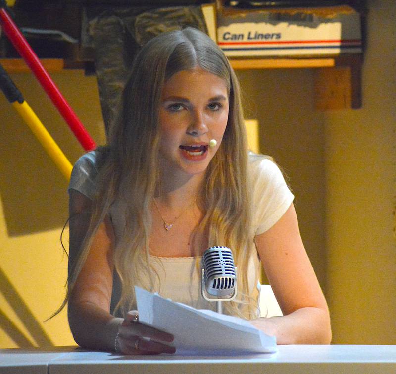Olivia Findley, junior as Bethany, performs the morning announcements in "Last Day of School."
