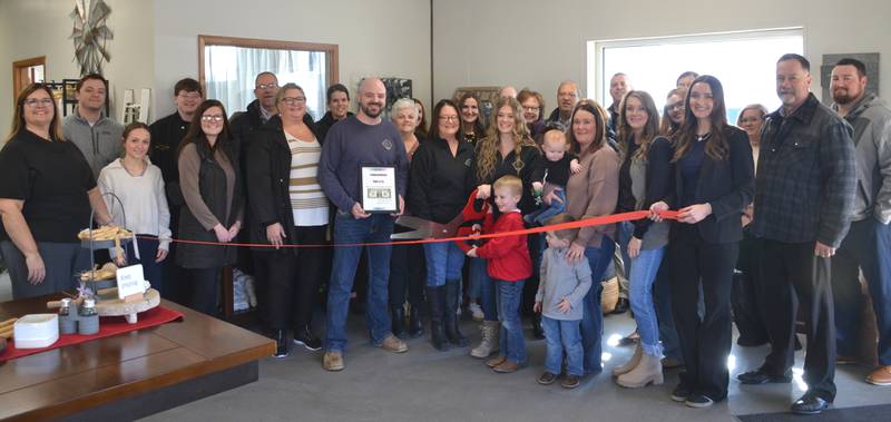 Adam Baker, Polly Luther and Hannah Baker celebrate the ribbon cutting for BaLu & Co., a floral and gift store located on North Walnut Street.