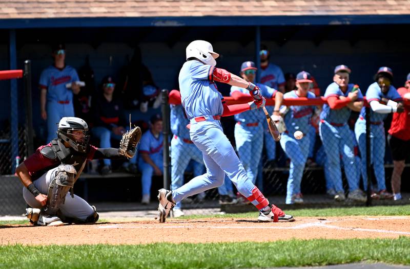 Southwestern’s Wyatt Throckmorton connects for a hit Tuesday in a home win against Indian Hills. The Spartans lost game two.