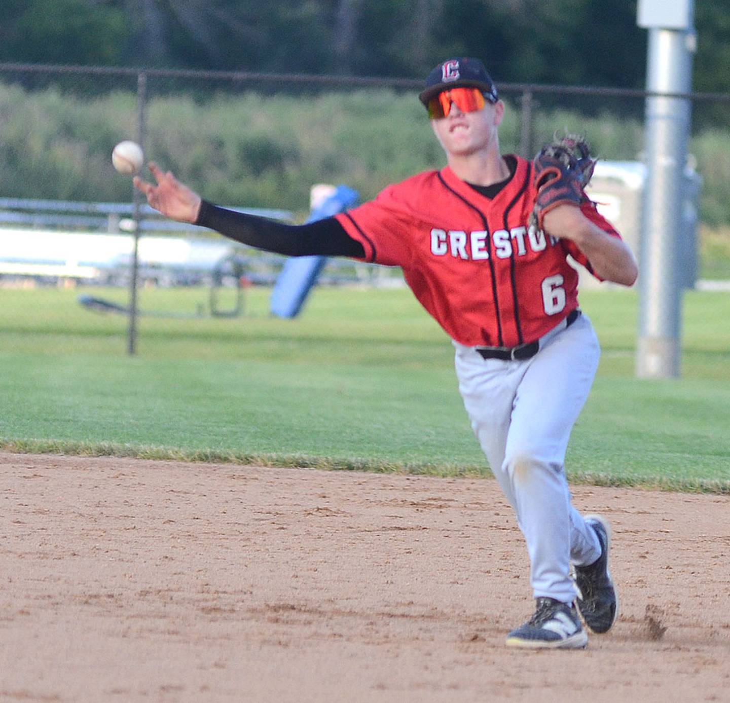 Creston second baseman Logan Stehr throws to first base after fielding a ground ball against Van Meter.