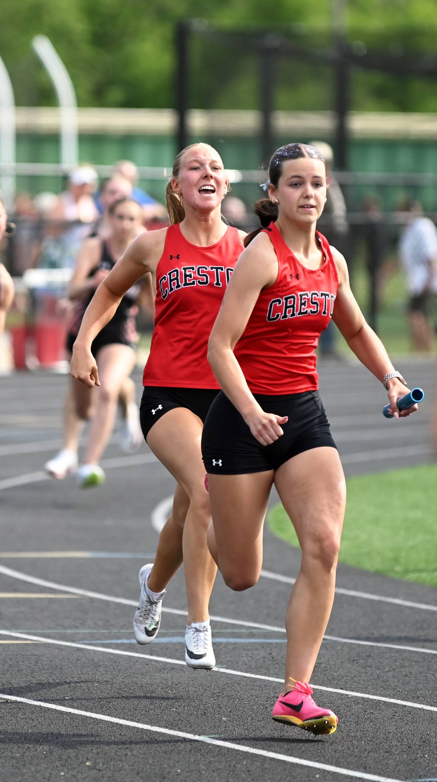 Avery Staver hands the baton to Braylee Pokorny in the sprint medley relay.
