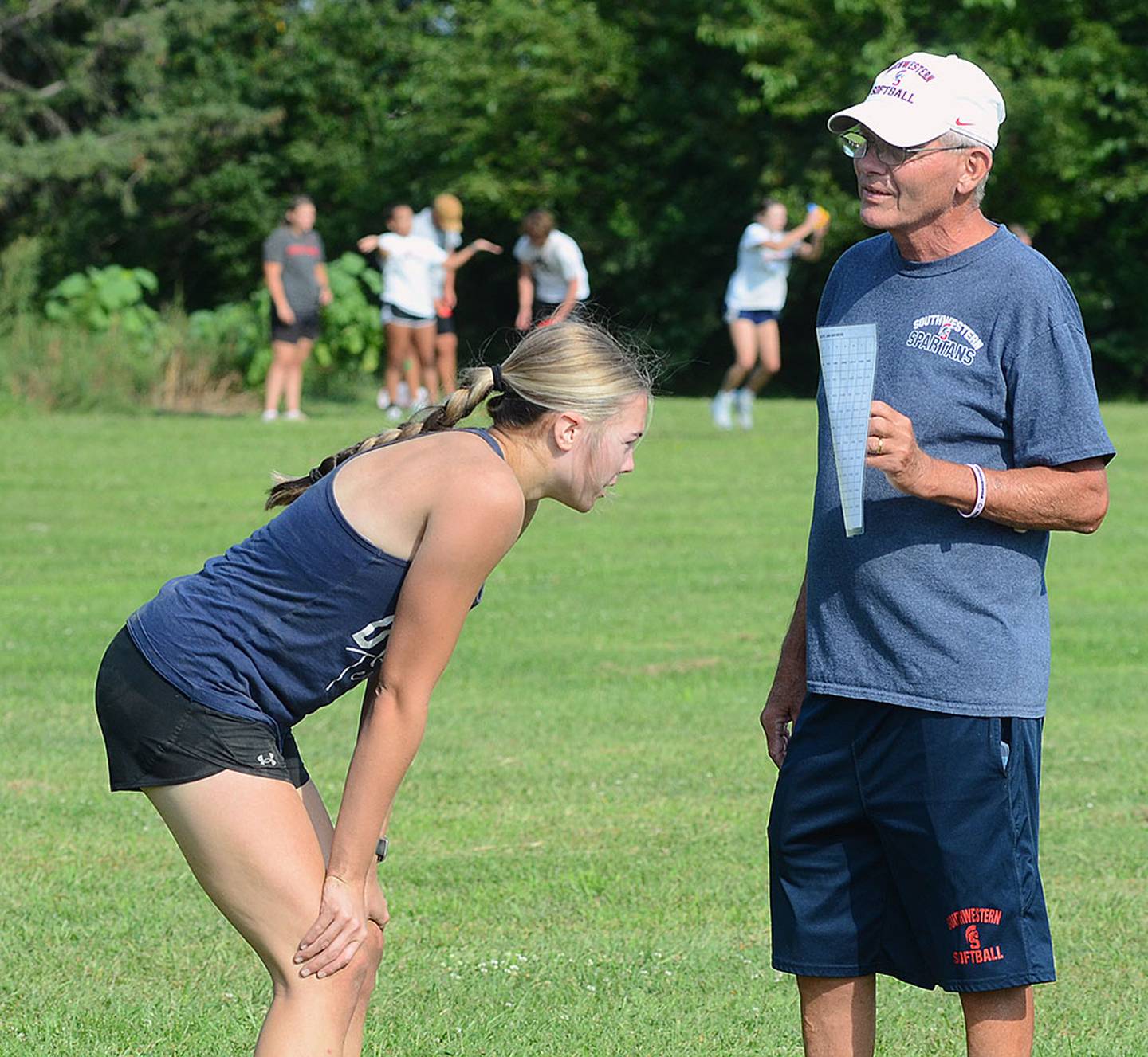An exhausted athlete who just completed an obstacle course is asked to memorize words on a page to report back to her teammates.