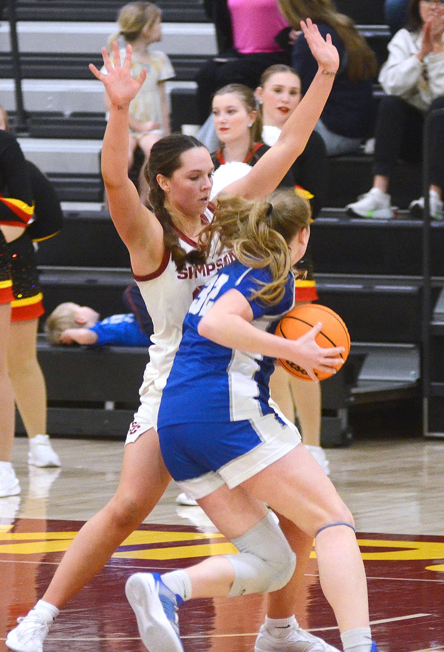 Simpson's Doryn Paup defends a move in the lane by Luther's Abigail Panka.