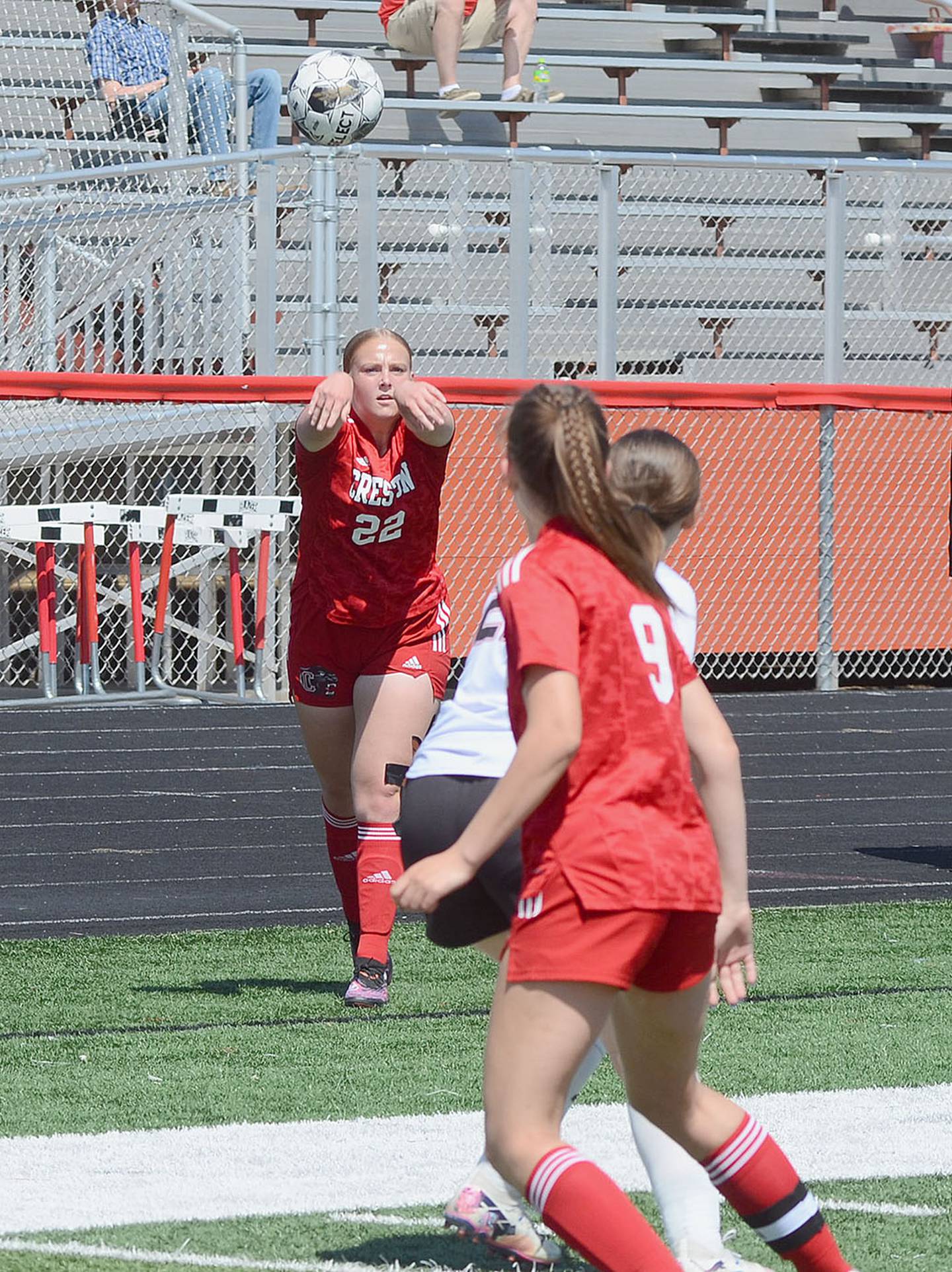 Lauren Purdum (22) executes a sideline pass to teammate Lillie Strode (9) during Saturday's 7-0 victory over Greene County.