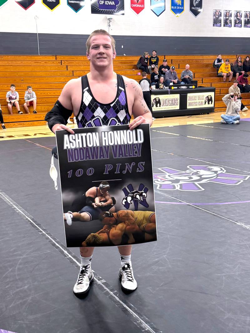 Ashton Honnold with a banner recognizing him for 100 pins in his career. He also broke the school record the same night for wins in a career.