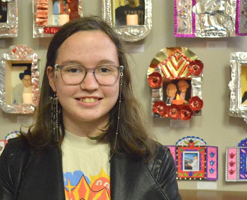 Olivia May Coenen beside a piece that she made honoring her grandparents.