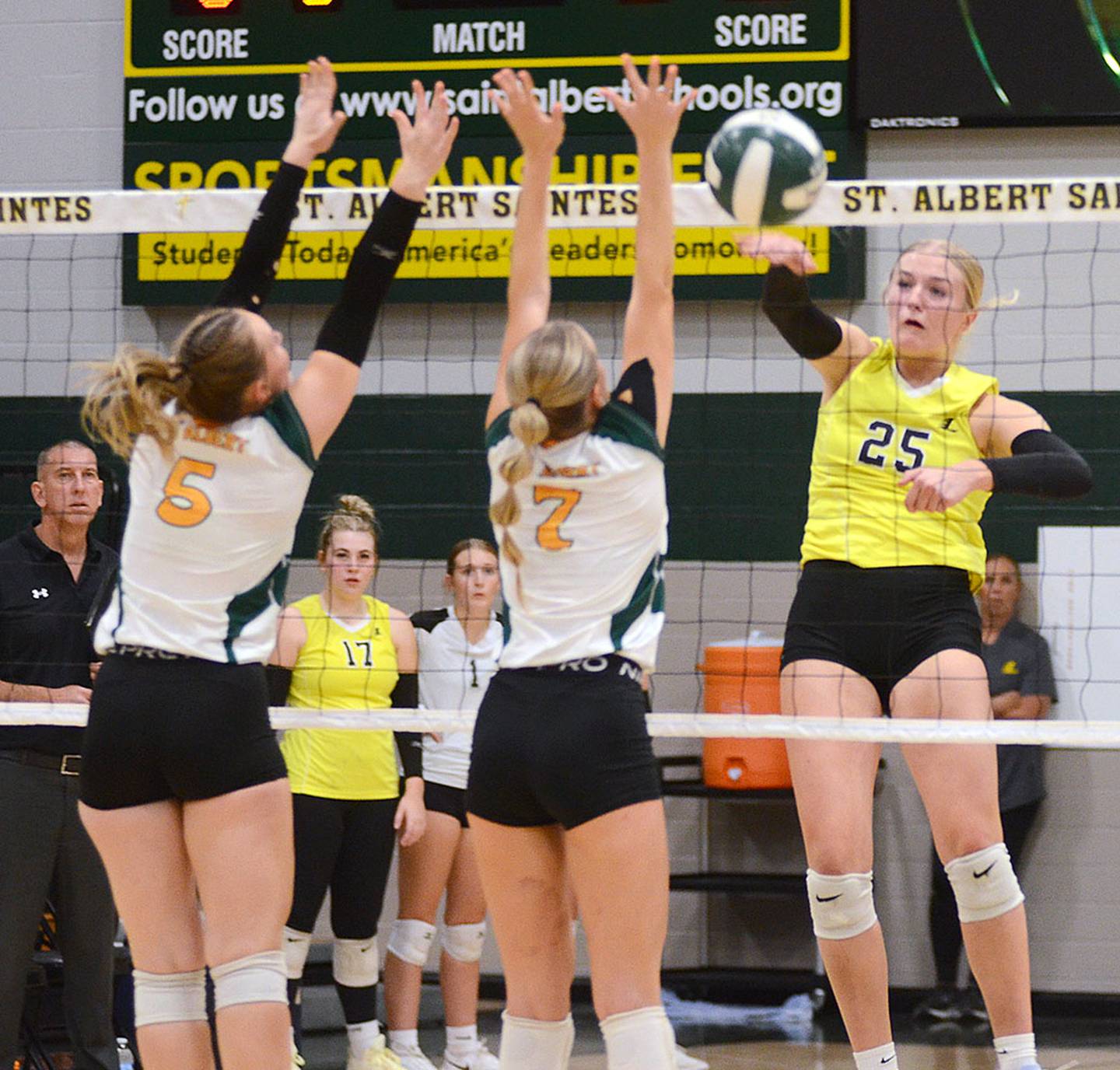Sadie Cox of Lenox sends a kill past St. Albert blockers Georgia Bohnet (5) and Kylie Wesack (7) during Monday's regional match. Cox, Lenox's career and single-season kills leader, had a team-high eight kills and 15 digs in the 3-0 loss.